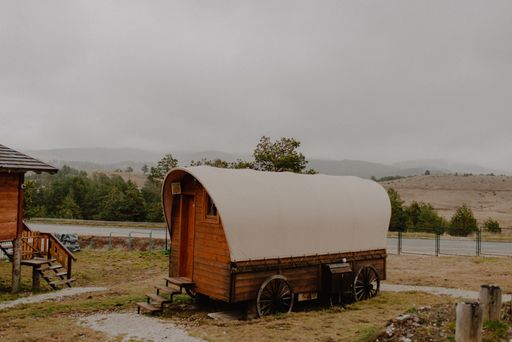 An old wooden building trailer as a tiny house in the garden