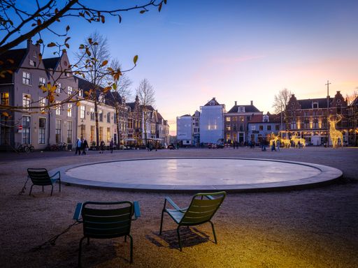 A beautiful view of chairs next to buildings in Deventer City in the Netherlands