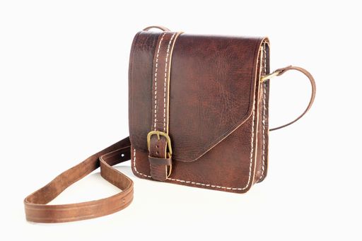 A closeup of a dark brown leather bag for men isolated on a white background
