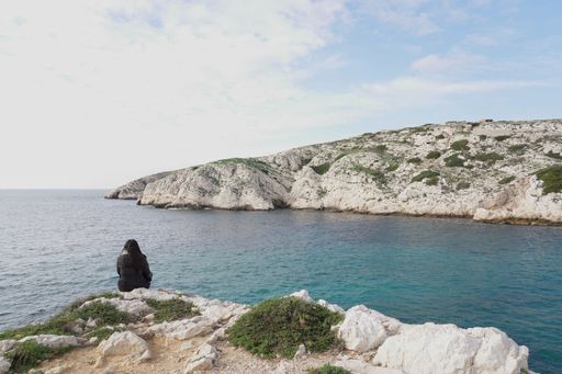 A young female traveler enjoying the picturesque views of the Frioul archipelago near Marseille, France