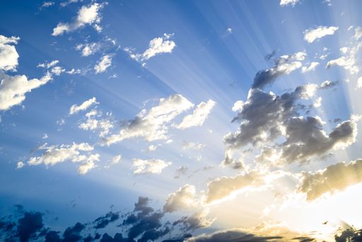 A breathtaking view of white clouds in blue sky with bright sunlight - great for wallpaper
