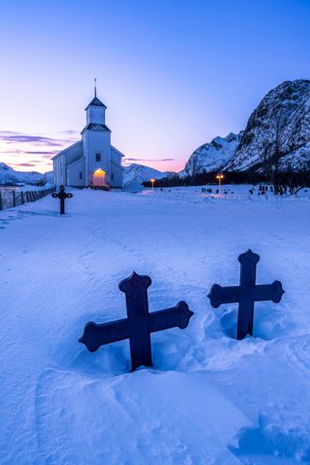 A snowy sunrise in Iceland, featuring crosses at the front of a beautiful church