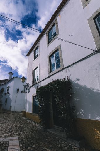 A low angle shot of facade building along the street in Cascais, Portug
