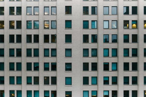 A brick made business building with windows in the city