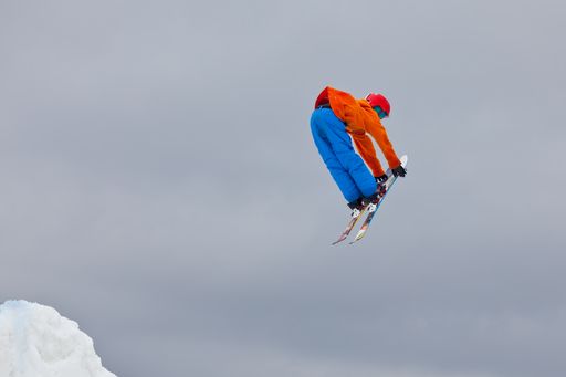 A snowboarder jumping high through the air at the Wisp Ski Resort in Deep Creek Lake Maryland