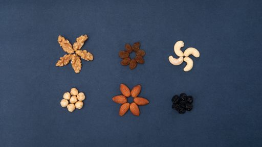 A high angle shot of nuts and seeds shaped like different signs and symbols