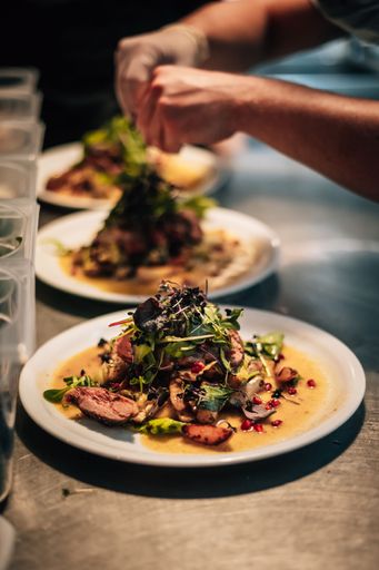 A chef making assorted foo, placed on a table in the foreground