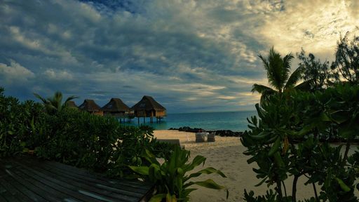 A beautiful shot of a sunset sky over the shore in Bora Bora, French Polynesia