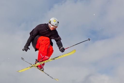 A professional skier making a high jump in the air during freestyle ski competition.