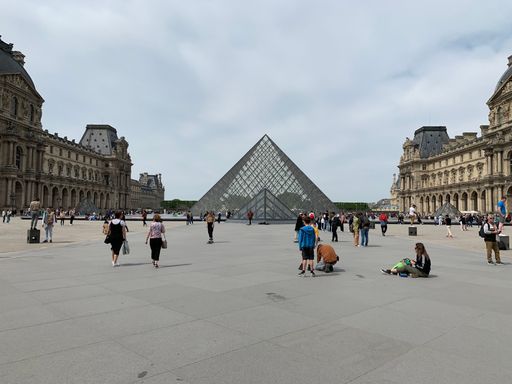 A quiet day near The Louvre Pyramid, Paris, a large glass and metal structure