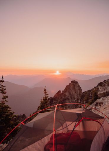 A vertical of a camp, set up in mountains of North cascades national park at the sunset, in Washington US