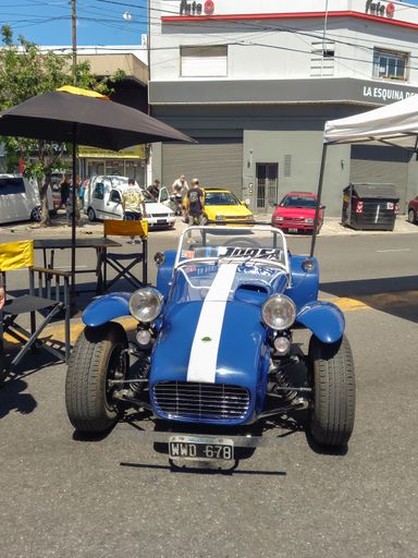Old classic 1970s Lotus Seven sport car in the street. Open top two seat speedster. Front view. High angle.