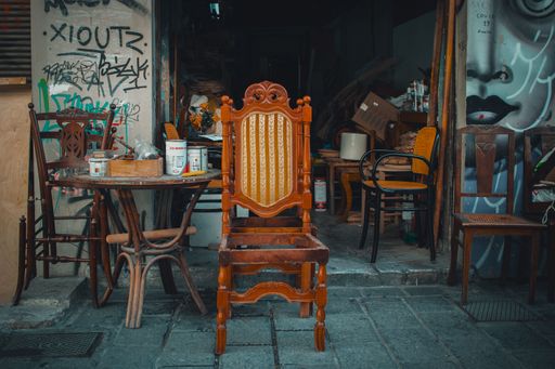 Athens, Greece - 2022: Old vintage wood chair in a street flea market on the streets of Athens.
