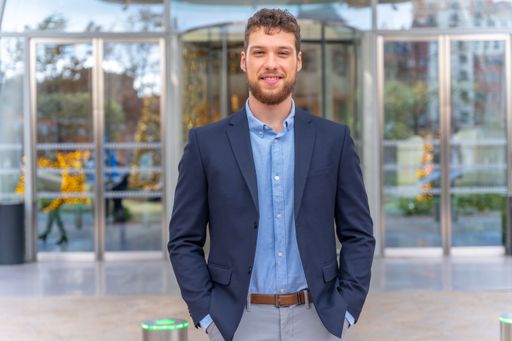 The portrait of handsome young businessman outside the office in a business park