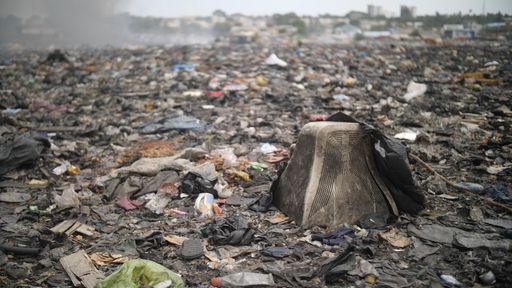 A closeup shot of abandoned trash on a polluted sea shore in Accra, Ghana