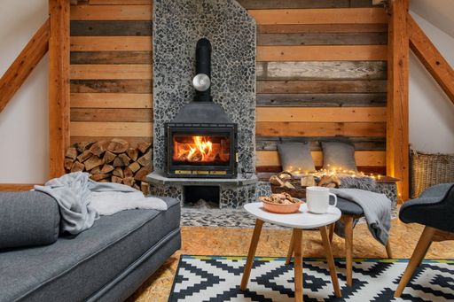 A cozy interior with a fireplace, couch, and coffee table