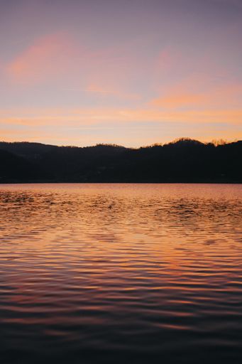 A vertical shot of scenery of a breathtaking sunset over the calm sea