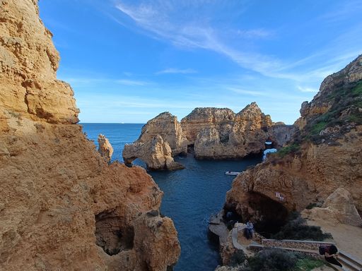 The sea stacks in the sea with a cloudy blue sky in the background, in Portugal