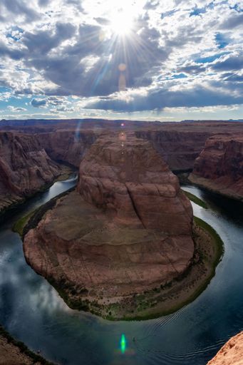 An aerial view of a river flowing through Horseshoe Bend on a sunny day in Colorado
