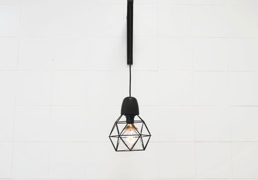 A closeup shot of a modern interior lamp on a white wall