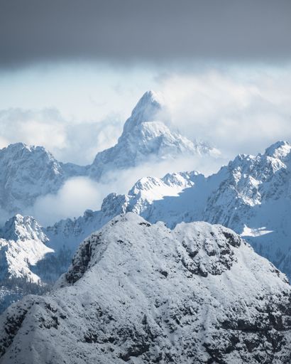 A vertical shot of the beautiful snow-covered mountains.