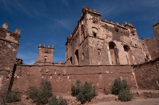 A low-angle shot of the ancient castle against a blue sky