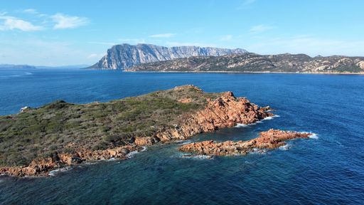 An aerial view of islands located on the Mediterranean sea seen on a beautiful sunny day