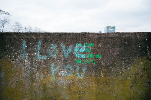 A colorful graffiti with the words I love you. With the street art love and a sweet saying is brought to the house wall.