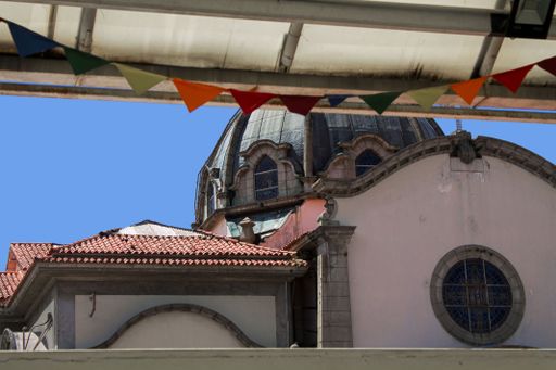 A large building adorned with colorful flags, showcasing vibrant architecture