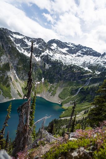 A vertical shot of a lake in a mountainous region on a cloudy day