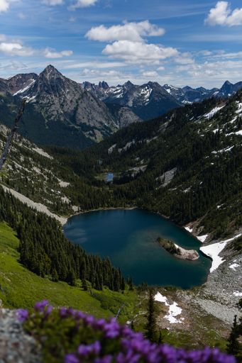 A vertical shot of a lake in a mountainous region on a cloudy day