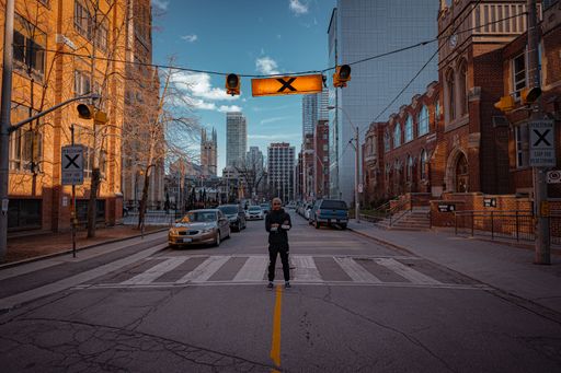 A man standing on the streets of Toronto, Canada