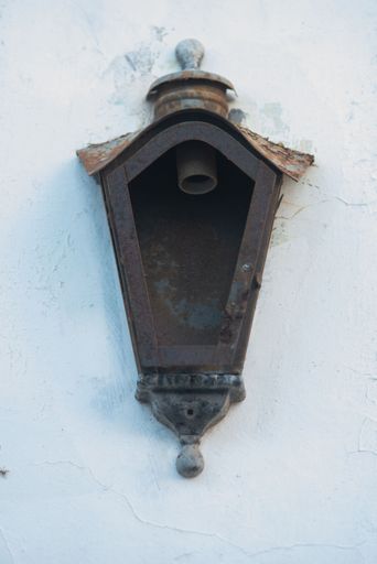 A vintage rusty wall light fixture.
