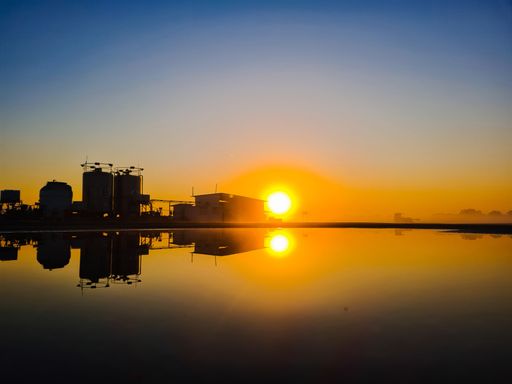 A scenic view of a fire station near a tranquil lake in Megiddo, Israel during a mesmerizing sunset