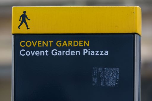 A signpost in the West End of London directs pedestrians and walkers towards the Covent Garden Piazza area of the city.