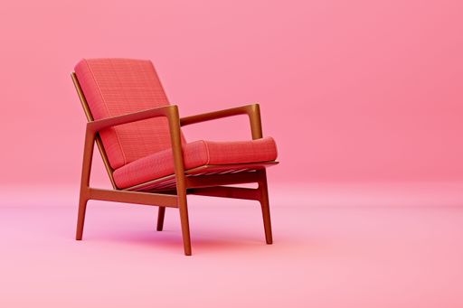 An antique wooden chair with a pink cushion in the pink studio, perfect for adding a vintage flair to any room