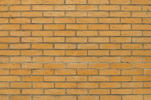 Yellow clinker brick wall texture as background
