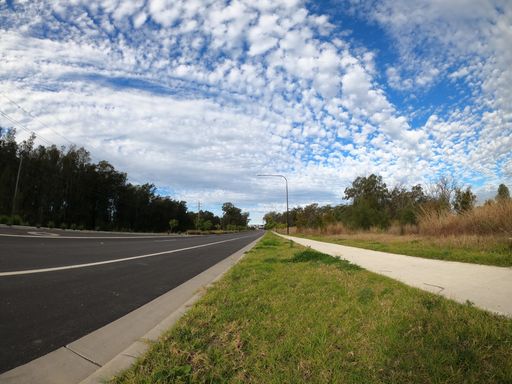 A beautiful view of a road surrounded by greenery in Schofield, New South Wales, Australia