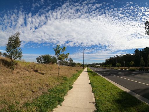 A beautiful view of a road surrounded by greenery in Schofield, New South Wales, Australia