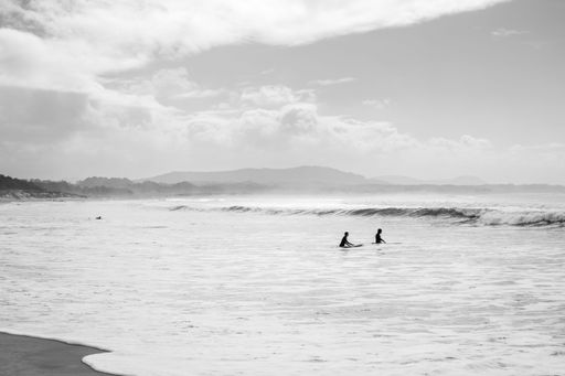 Beach with surfers entering in the water, Viana do Castelo, Portugal