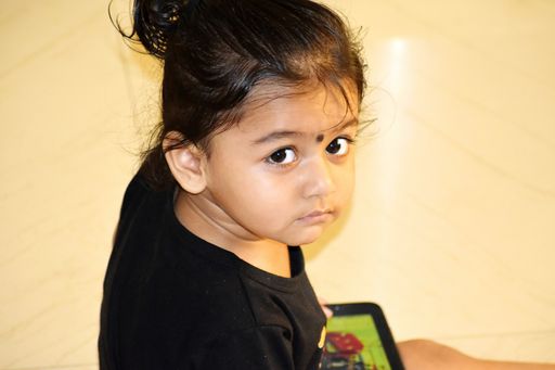 A little Indian baby girl with a smartphone