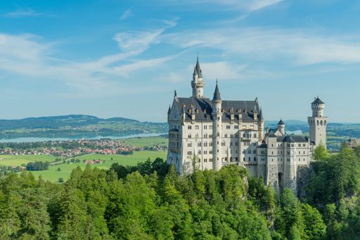 A beautiful view of Neuschwanstein Castle on green landscape in Germany