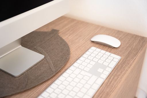 The modern workplace with desktop computer, working table, keyboard and mouse