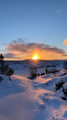 A vertical view of a sunset over snowy landscapes