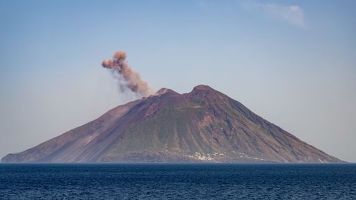 An aerial shot of a volcanic eruption occurring in the ocean in Sicily