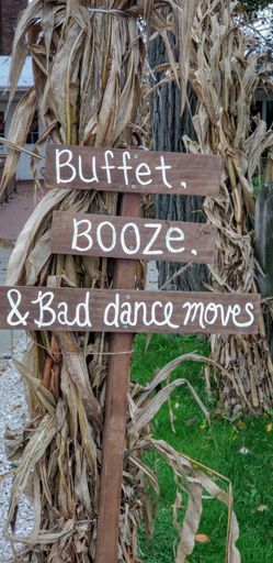 A vertical shot of a signboard with the writing "'Buffet, booze, and bad dance moves"
