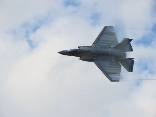 A low angle shot of a F-35 Lightning 2 plane flying at a show