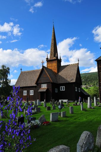 A mesmerizing shot of the Lesja wooden church with its cemetery, in the village of Lesja, Norway