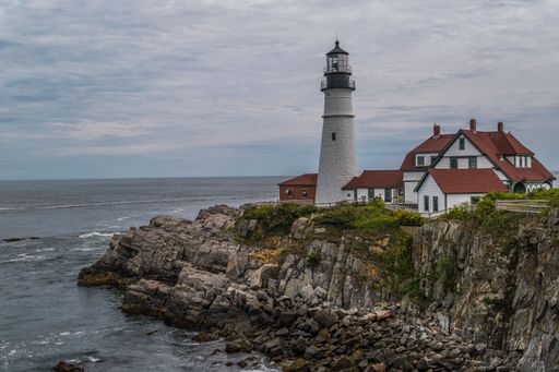 A beautiful view of Portland Head Lighthouse in Cape Elizabeth, Maine on a cliff near the sea