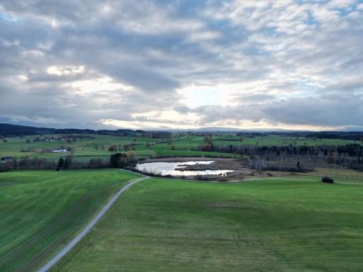 An aerial view of green valleys near a stream in Habach, Germany